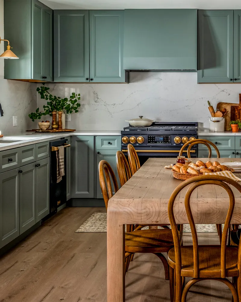 THOR Kitchen 36 inch range with bronze trim in a green kitchen