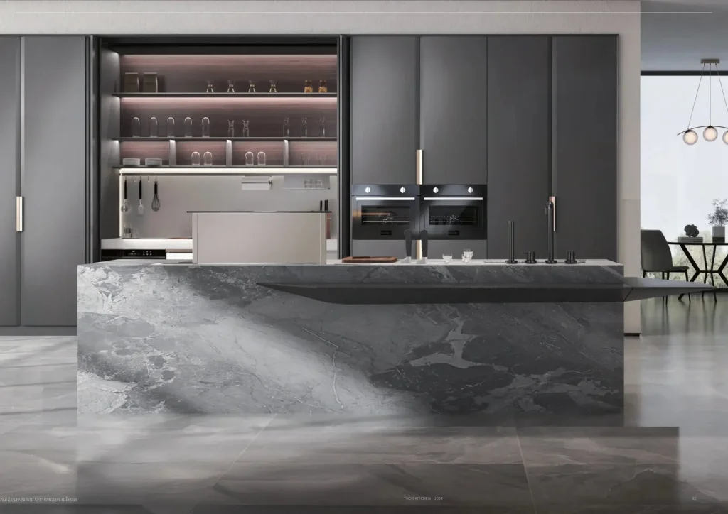 Stainless steel kitchen with a stone-topped island by THOR Kitchen